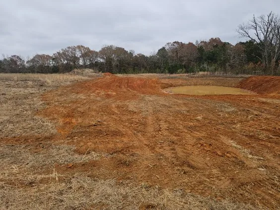 Freshly shaped pond and surrounding ground
